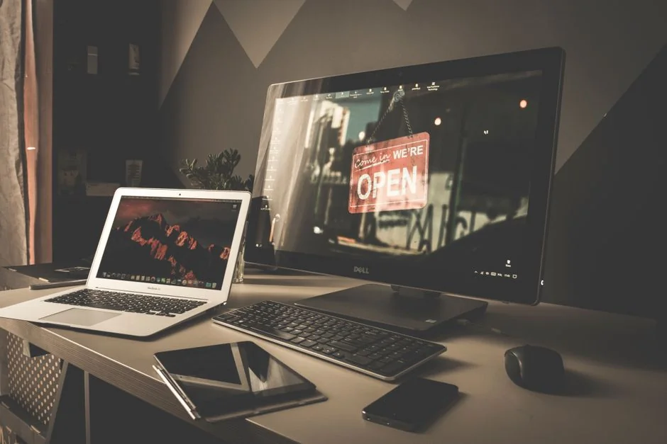 creative-01 Man in a home office setup working on web design with dual monitors.